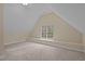 An open concept bedroom with neutral tones and a large window for natural light at 5600 Thornburg Dr, Wake Forest, NC 27587
