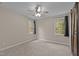Neutral bedroom featuring two windows and a decorative barn door entrance to an adjacent room at 5600 Thornburg Dr, Wake Forest, NC 27587