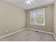 Neutral bedroom with carpet, a ceiling fan, and a window for natural light at 5600 Thornburg Dr, Wake Forest, NC 27587