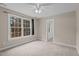 Cozy, carpeted bedroom with a ceiling fan and a large window with natural light at 5600 Thornburg Dr, Wake Forest, NC 27587