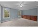 Bright bedroom features carpeted flooring, large windows providing ample natural light, and a built-in storage dresser at 5600 Thornburg Dr, Wake Forest, NC 27587