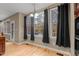 Bright dining area featuring large windows with black curtains and hardwood flooring at 5600 Thornburg Dr, Wake Forest, NC 27587
