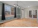 Dining room with hardwood floors, modern lighting, and french doors at 5600 Thornburg Dr, Wake Forest, NC 27587
