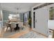 Bright dining room with hardwood floors, modern lighting, and a beautiful accent wall at 5600 Thornburg Dr, Wake Forest, NC 27587