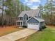 Classic two-story home features a charming front porch, two-car garage, and ample parking at 5600 Thornburg Dr, Wake Forest, NC 27587
