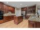 Gourmet kitchen with stainless steel appliances, custom cabinets, granite counters, and a spacious center island at 5600 Thornburg Dr, Wake Forest, NC 27587