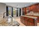 Spacious kitchen with granite counters, stainless steel sink, and view to the dining area at 5600 Thornburg Dr, Wake Forest, NC 27587
