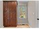 Neutral colored room with wooden floors, large window, and large wooden storage cabinet at 5600 Thornburg Dr, Wake Forest, NC 27587