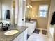 Elegant bathroom featuring a granite vanity and modern fixtures at 1008 Willow Ridge Dr, Knightdale, NC 27545