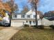 Two-story house with white siding, blue shutters, and a two-car garage at 1008 Willow Ridge Dr, Knightdale, NC 27545