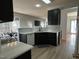 Modern kitchen with dark cabinetry, quartz countertops and hardwood floors at 1008 Willow Ridge Dr, Knightdale, NC 27545