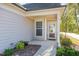 Charming front entrance with covered porch and well-lit walkway at 219 Rosedale Creek Dr, Durham, NC 27703