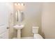 Charming half-bathroom with a pedestal sink, neutral walls, and modern fixtures at 219 Rosedale Creek Dr, Durham, NC 27703