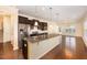 Open kitchen with granite counters, stainless steel appliances, and rich wood floors perfect for entertaining at 219 Rosedale Creek Dr, Durham, NC 27703