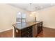 Sleek kitchen island with stainless steel sink and dishwasher, complemented by elegant pendant lighting at 219 Rosedale Creek Dr, Durham, NC 27703