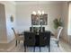 Elegant dining room with dark wood table, light walls, and botanical artwork at 37 Streamline Ct, Lillington, NC 27546