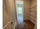 Walk-in pantry with wire shelving, hardwood floors and natural light from the window at 37 Streamline Ct, Lillington, NC 27546