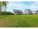 Expansive backyard with a covered porch offers plenty of space for recreation and relaxation at 617 Darian Woods Dr, Holly Springs, NC 27540