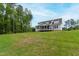 Large backyard featuring a covered porch, offering plenty of space for outdoor activities at 617 Darian Woods Dr, Holly Springs, NC 27540