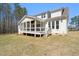 An inviting backyard showcases a spacious porch perfect for outdoor entertaining and relaxation at 617 Darian Woods Dr, Holly Springs, NC 27540