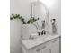 Bathroom vanity featuring a white marble countertop, modern faucet, and decorative mirror at 617 Darian Woods Dr, Holly Springs, NC 27540