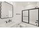 A sophisticated bathroom featuring an ornate black mirror and sleek black shower door at 617 Darian Woods Dr, Holly Springs, NC 27540