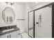 Modern bathroom featuring a glass shower with black trim, vanity, and decorative mirror at 617 Darian Woods Dr, Holly Springs, NC 27540