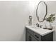 A bathroom vanity with a decorative mirror, marble countertop, and matte black fixtures at 617 Darian Woods Dr, Holly Springs, NC 27540