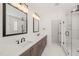 Elegant bathroom with double vanity, marble countertops, and a glass-enclosed shower at 617 Darian Woods Dr, Holly Springs, NC 27540