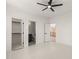Bedroom featuring a ceiling fan, bathroom entry, and closet access offering comfort and convenience at 617 Darian Woods Dr, Holly Springs, NC 27540