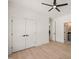 Bright bedroom with a ceiling fan, wood floor, and large closet at 617 Darian Woods Dr, Holly Springs, NC 27540