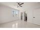 Bright bedroom featuring a ceiling fan, walk-in closet, bathroom entry, and a view of lush trees at 617 Darian Woods Dr, Holly Springs, NC 27540