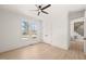 Bright bedroom featuring a ceiling fan, light walls, wood-look floors, and closet at 617 Darian Woods Dr, Holly Springs, NC 27540