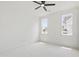 Cozy bedroom with neutral carpet, two windows for natural light, and a ceiling fan for added comfort at 617 Darian Woods Dr, Holly Springs, NC 27540