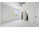 A bright bedroom with white carpet, large windows, and ensuite bathroom and closet at 617 Darian Woods Dr, Holly Springs, NC 27540