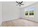 Bedroom featuring hardwood style floors, a ceiling fan, and bright windows at 617 Darian Woods Dr, Holly Springs, NC 27540