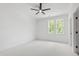 A bright bedroom featuring neutral carpet, large windows, and a ceiling fan at 617 Darian Woods Dr, Holly Springs, NC 27540