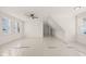 Bright bonus room with white walls, ceiling fan and multiple windows providing ample natural light at 617 Darian Woods Dr, Holly Springs, NC 27540
