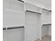 Well-organized closet with built-in shelves, hanging rods, and wood floors at 617 Darian Woods Dr, Holly Springs, NC 27540