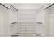 Organized walk-in closet featuring multiple shelves and hanging rods for optimal storage at 617 Darian Woods Dr, Holly Springs, NC 27540