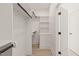 Walk-in closet features custom shelving, hanging rods, and a bright interior at 617 Darian Woods Dr, Holly Springs, NC 27540