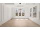 Bright dining area featuring recessed lights, a modern chandelier, large windows, and wood-look floors at 617 Darian Woods Dr, Holly Springs, NC 27540