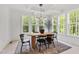 Bright dining room with lots of windows and views of the surrounding green space at 617 Darian Woods Dr, Holly Springs, NC 27540