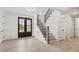 Inviting home entryway featuring hardwood floors, staircase with iron railing, and black-framed front door at 617 Darian Woods Dr, Holly Springs, NC 27540
