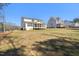 Backyard view of two-story homes with screened porches offering stunning views and outdoor living spaces at 617 Darian Woods Dr, Holly Springs, NC 27540