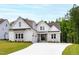 Beautiful two-story home featuring white siding, stone accents, and a well-manicured lawn at 617 Darian Woods Dr, Holly Springs, NC 27540
