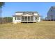 Rear view of two-story house with a screened porch provides scenic beauty and a peaceful ambiance at 617 Darian Woods Dr, Holly Springs, NC 27540