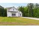 New home with stone and siding accents, beautiful lawn, and long driveway at 617 Darian Woods Dr, Holly Springs, NC 27540