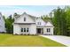 New construction farmhouse-style home featuring a manicured lawn and driveway at 617 Darian Woods Dr, Holly Springs, NC 27540