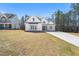 Charming new home features a modern farmhouse facade with stone accents and a well-manicured lawn at 617 Darian Woods Dr, Holly Springs, NC 27540